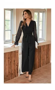 Detail of elegant black jumpsuit showing sheer chevron textured sleeves and ruffled cuffs