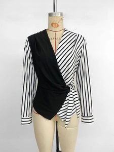 Detail of V-neck wrap blouse with contrast stripes and adjustable side waist tie
