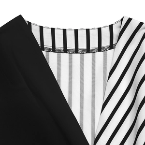 Detail of V-neck shirt with contrast patchwork black fabric and white stripes