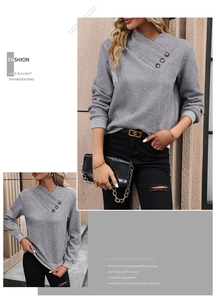 Detail view of grey long sleeve sweatshirt with diamond embossed texture and button neck