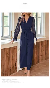 Detail of navy blue jumpsuit with mesh textured long sleeves and belted waist design