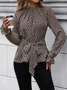Detail of flared cuffs and waist tie on women's geometric print long sleeve shirt
