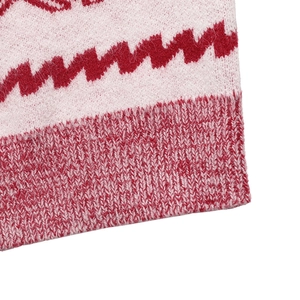 Close-up of pink and red knit sweater showing wavy pattern and ribbed hem detail