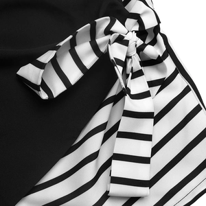 Detail of the chic black v-neck shirt featuring a black and white striped waist bow tie