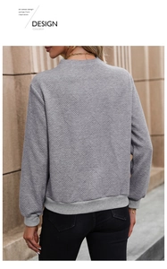 Detail of grey sweatshirt back showing diamond embossed texture and casual knit fabric