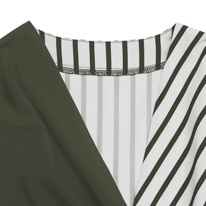 Detailed close-up of V-neck collar featuring contrast green and vertical striped patterns