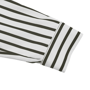 Detail of long sleeve shirt cuff with green and white stripes and neat flat stitching