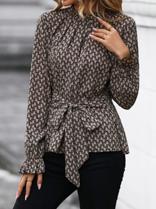 Detail of ruffled high collar and bow tie waist on a slim leopard print blouse