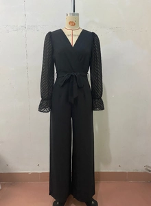Detailed view of the sheer mesh sleeves with textured chevron pleats and ruffled cuffs
