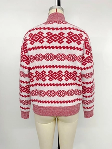Detailed back view of a red and white knitted sweater with traditional geometric patterns