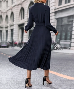 Vue arrière d'une robe mi-longue plissée bleu marine à manches longues avec ceinture