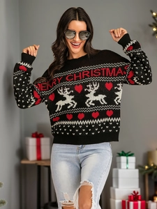 Detail of knit Christmas reindeer sweater with Merry Christmas lettering and snowflake pattern