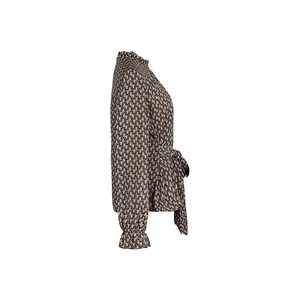 Detail of ruffled stand collar and waist tie bow on the beige long sleeve blouse