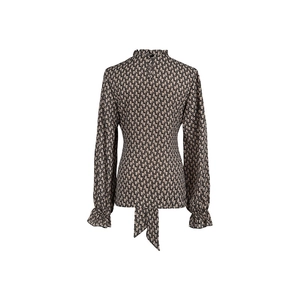 Detail view of the back of a leopard print blouse featuring a ruffled collar and tie-back hem
