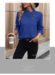 Detail of the navy blue sweatshirt featuring unique asymmetric neck and vintage metal buttons