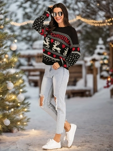 Close-up of the knitted reindeer pattern and Christmas text on this winter sweater