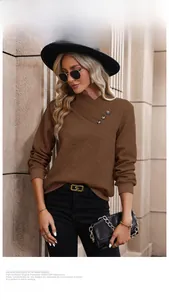 Detail of coffee brown knit sweater featuring elegant V-neckline with decorative buttons