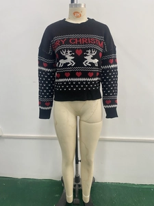 Close-up of black Christmas sweater with reindeer jacquard and red Merry Christmas text