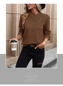 Close-up of brown waffle knit sweater featuring overlapping V-neck with decorative buttons