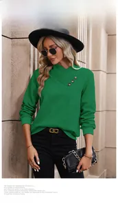 Detail of dark green waffle knit texture and cross V-neck with button accents