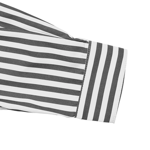 Close-up of striped shirt cuff featuring horizontal and vertical woven patterns