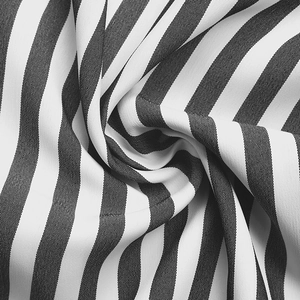 Detailed close-up showing the fine texture of black and white vertical striped cotton fabric