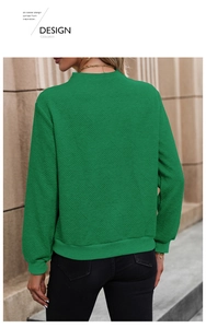 Detail of green long-sleeve sweatshirt showing diamond quilted texture and ribbed cuffs