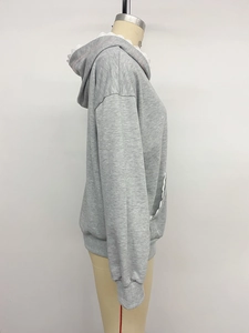 Detail view of grey hoodie featuring white lace trim on hood and ribbed cuffs on sleeve