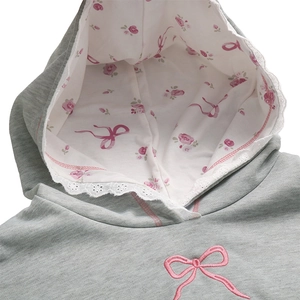 Detail of grey hoodie with pink bow embroidery, lace trim and floral lining on the hood