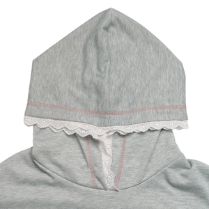 Detail of grey hoodie featuring white lace trim on hood and pink contrast stitching