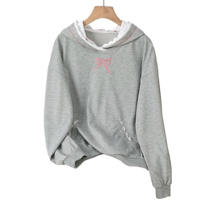 Gray hoodie for women with pink bow embroidery and white lace trim details on a wooden hanger