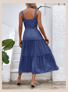 Back view of a blue tiered summer midi dress featuring elastic ruched back and thick straps