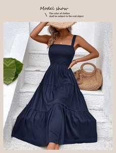 Detail of navy blue smocked bodice and tiered maxi dress for summer beach vacation