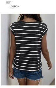 Detail of black and white striped t-shirt featuring golden button accents on short sleeves