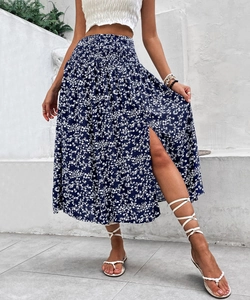 Detailed shot of high waist elastic band and white floral print on a blue midi skirt