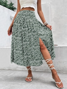 Detail view of the smocked high waist and side slit on the floral bohemian skirt