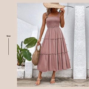 Detail of the smocked bodice and tiered hem on this pink summer sleeveless dress
