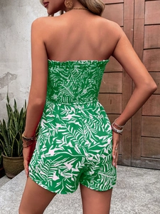 Detail of smocked waist and tropical leaf print on back of summer romper