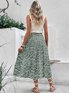 Detail of high waist green floral midi skirt with elastic pleated waist and A-line hem