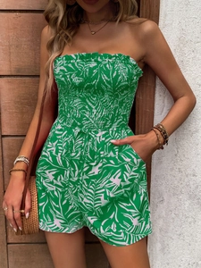 Detail of tropical leaf print on strapless green romper with elastic waist and drawstring
