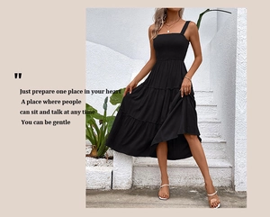 Detail of black smocked tiered dress with square neck and elegant ruffles for summer holidays