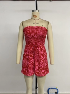 Detail of tropical leaf print and smocked tube top on a summer beach romper