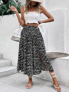 Detail of high-waist elastic shirring and side slit on blue floral print midi skirt