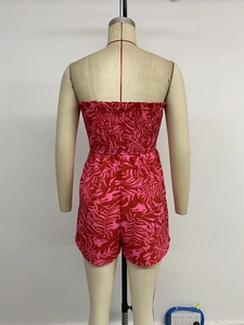 Detail view of the elastic smocked back on a tropical leaf print summer romper