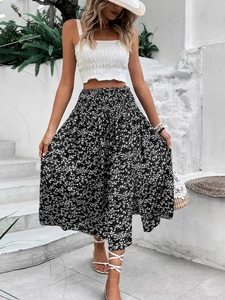 Close-up detail of high waist elastic smocking on floral print maxi skirt for vacation
