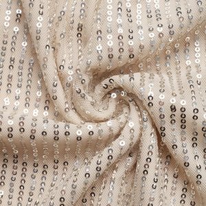 Macro shot of vertical champagne sequin patterns on soft mesh fabric detail