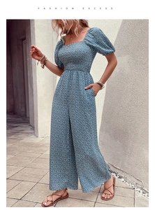 Close-up of floral print romper featuring square neck, puff sleeves and pleated high waist