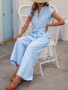 Detail view of the v-neck blue and white striped sleeveless jumpsuit with waist tie