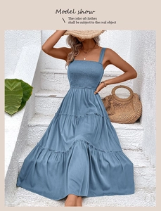 Detail view of blue smocked bodice and tiered maxi sun dress with ruffled layers