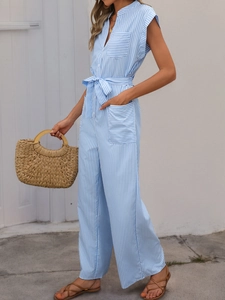 Detail of blue striped sleeveless jumpsuit with buttoned V-neck and waist tie design